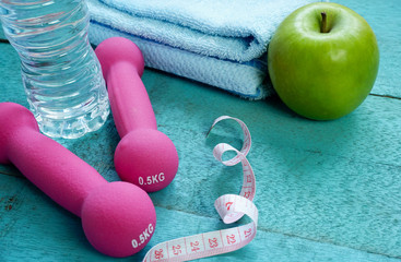 Fitness Concept. Fitness equipment on blue wooden background.