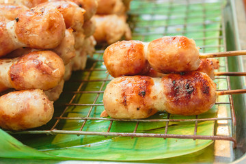 East sausage being grilled, Thai food style.
