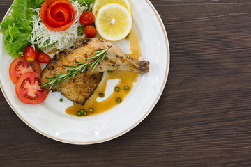 Grilled Chicken steak with black pepper and teriyaki sauce In white dish and vegetables in the basket on the wooden table