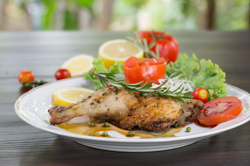Grilled Chicken steak with black pepper and teriyaki sauce In white dish and vegetables in the basket on the wooden table