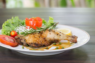 Grilled Chicken steak with black pepper and teriyaki sauce In white dish and vegetables in the basket on the wooden table