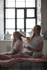 Beautiful mother takes care of  teenage daughter