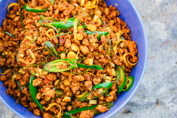 Stir fried pork with yellow curry paste, Thai food.