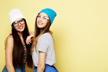 lifestyle and people concept: Two girl friends standing together