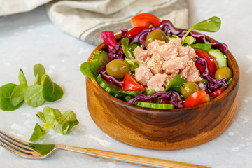 Tuna salad with vegetables and olives. Healthy raw nutrition concept.
