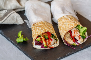 Homemade spicy tortilla wrap with a mix of ingredients: chicken, vegetables and ricotta.