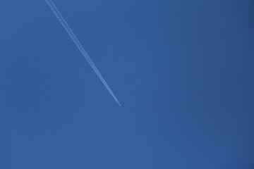 Airplane while flying in air on blue sky