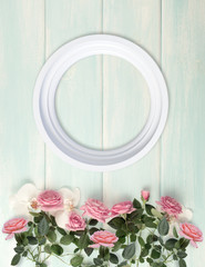 Wooden background with frame, roses and orchid flowers