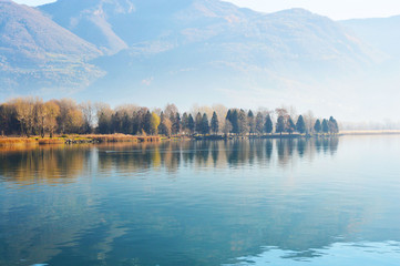 Fototapeta premium Beautiful landscape of Lake Iseo with forest and reflection in the water, Lovere, Italy 