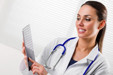 Smiling Female doctor Working on digital Tablet