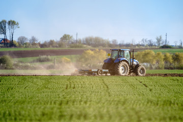 Tractor harrowing the land