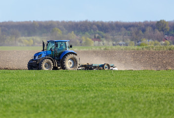 Tractor harrowing the land