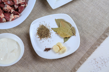 Seasoning. Pepper, garlic, bay leaf, a paprika, a basil on a plate