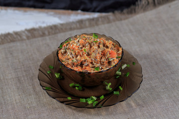 Salad from chicken hearts and a liver with carrot a cucumber egg and sauce