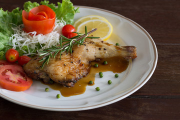 Grilled Chicken steak with black pepper and teriyaki sauce In white dish and vegetables on the wooden table