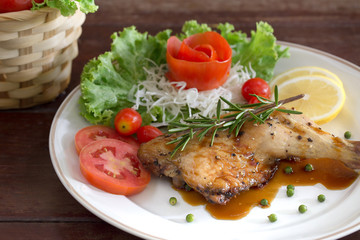Grilled Chicken steak with black pepper and teriyaki sauce In white dish and vegetables in the basket on the wooden table
