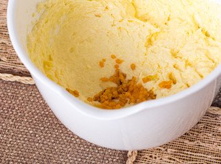 Adding candied orange peel to dough.
