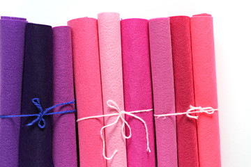 Pink and lilac felt in rolls . Creativity and hobby concept