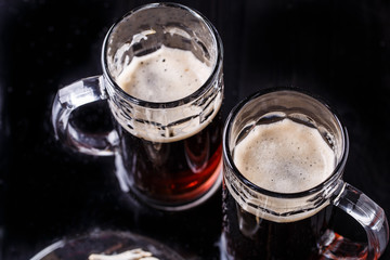 Mugs of beer on table