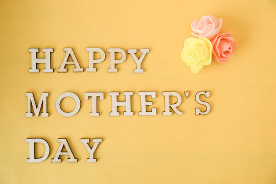 happy mother's day text, yellow background