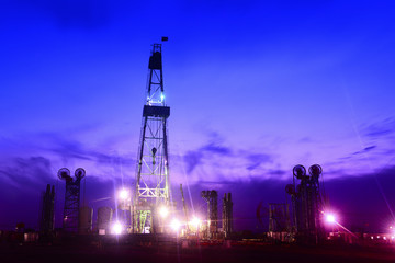 Pumping unit in the work, under the background of the setting sun