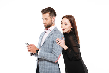 Happy young loving couple standing isolated