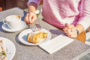 Woman eats desert on breakfast.
