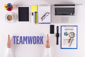 Businessman working on desk - hands showing TEAMWORK concept
