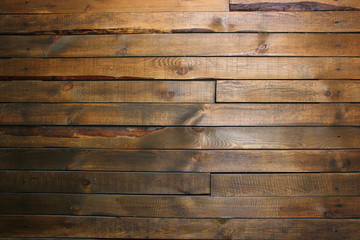 Naklejka premium Wall with dark brown wooden horizontal panels (pallets). Background