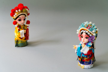 Fototapeta premium Traditional married Chinese dolls isolate on gray background - focusing on groom