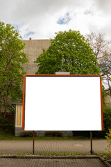 Empty white billboard before trees and sky