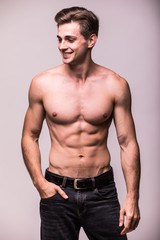 Fototapeta premium Healthy athlete muscular young man on a gray background