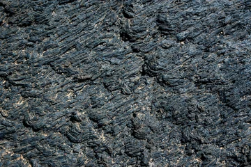 Outdoor kussens Black cold lava textured background in Lanzarote, Canary Islands, Spain © Delphotostock