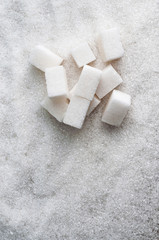 sugar as background and cubes of white sugar