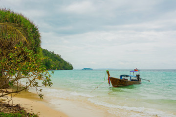 Fototapeta na wymiar Andaman's island with long tale taxi boats on a beach