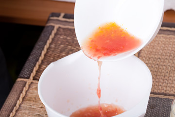 White bowl with fresh grapefruit juice.
