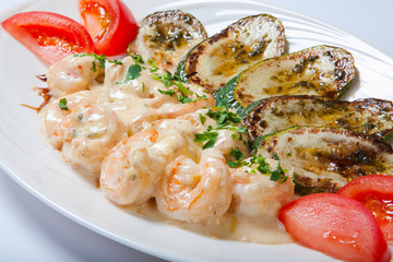 shrimps and grilled zucchini on a white plate