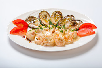shrimps and grilled zucchini on a white plate