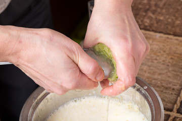 Squeezing lime with metal spoon.