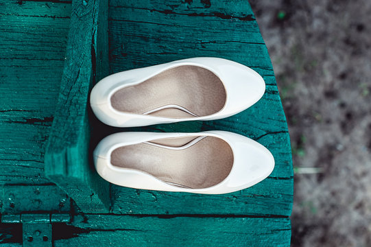 bride's biege shoes on heel on a wooden board tiffany colour