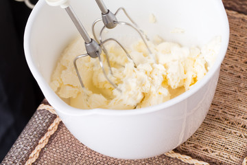 Mixing cake dough with butter.