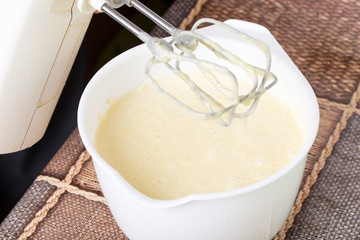 Mixing cake dough in saucepan.