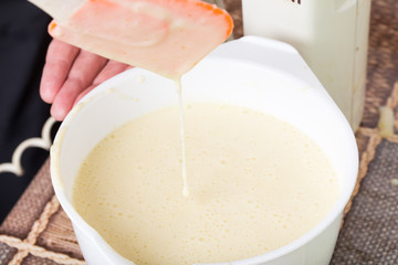 Mixing cake dough in saucepan.