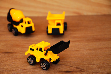 Group of small heavy construction machine toy, lorry, bulldozer and concrete mixer. All made of...