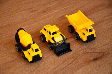 Group of small heavy construction machine toy, lorry, bulldozer and concrete mixer. All made of...