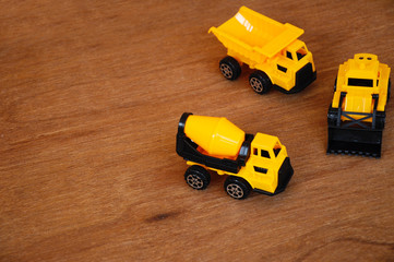 Group of small heavy construction machine toy, lorry, bulldozer and concrete mixer. All made of...