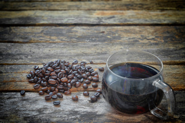 Coffee cup and coffee beans on a wooden table