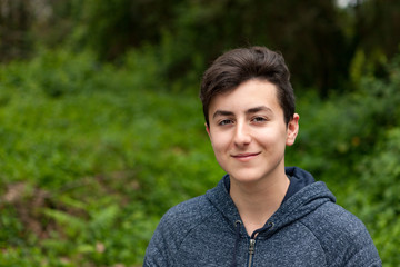 Attractive teenager guy in a park