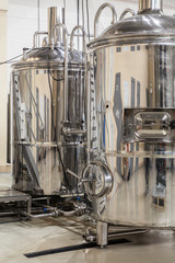 Brewery. Modern beer plant with brewering kettles, tubes and tanks made of stainless steel