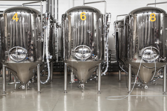 Brewery. Modern beer plant with brewering kettles, tubes and tanks made of stainless steel